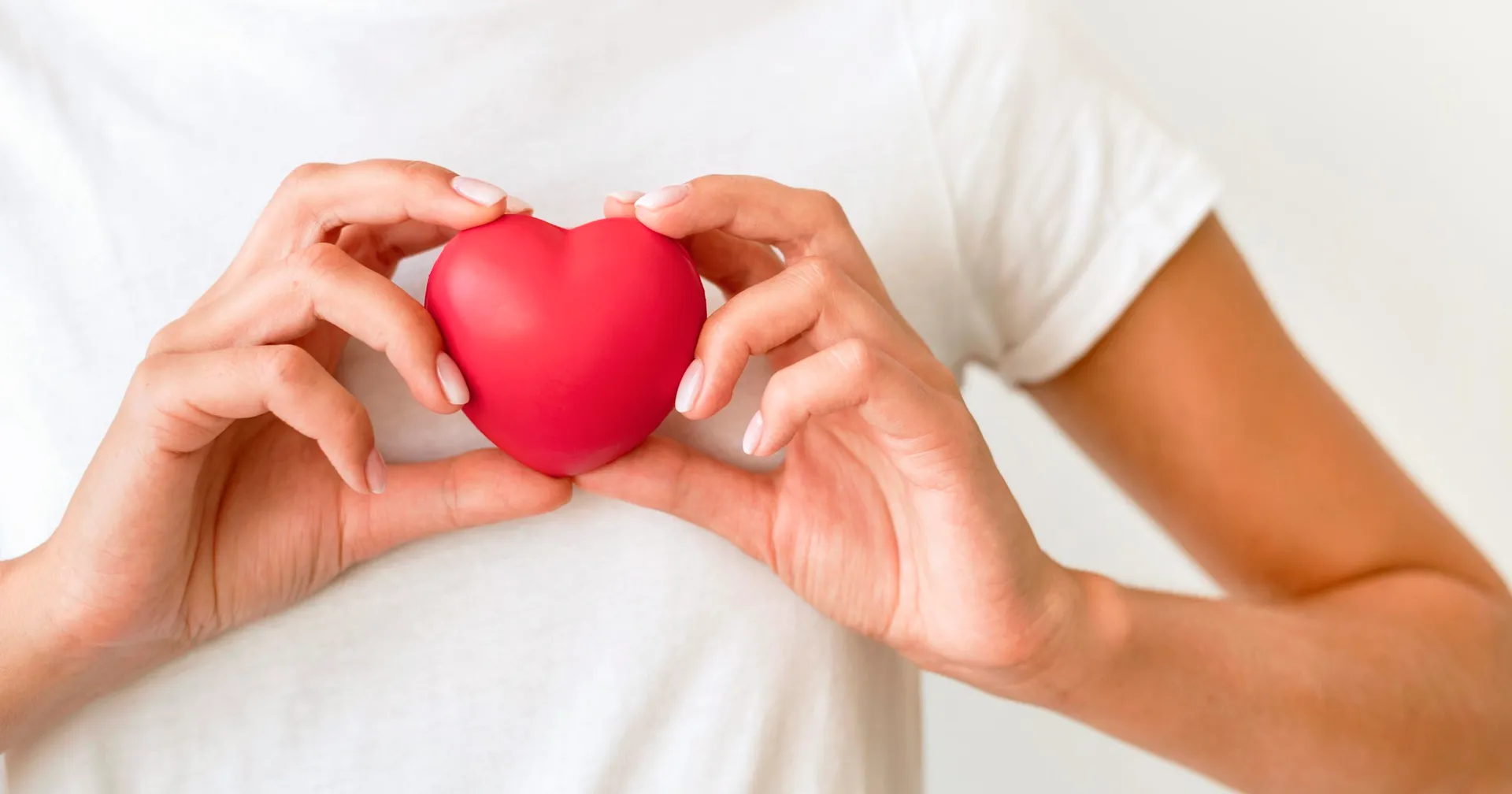 front-view-woman-holding-heart-shape-scaled