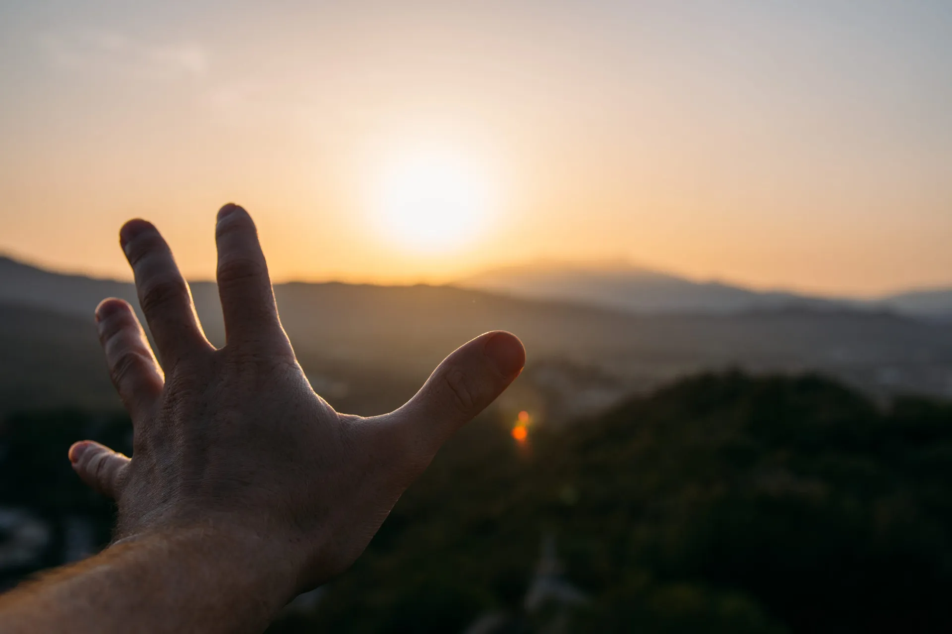 open-hand-direction-horizon-with-beautiful-sunset-scaled