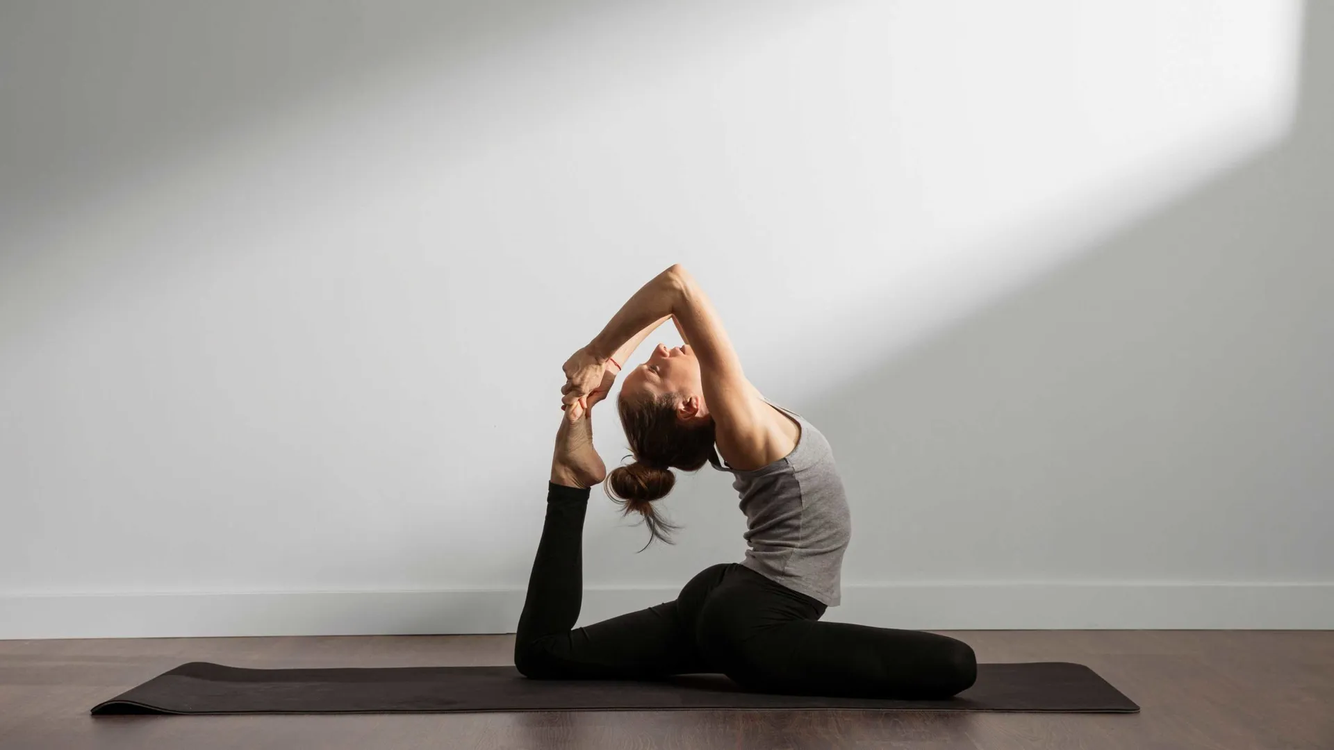 active-woman-practicing-yoga-home-scaled