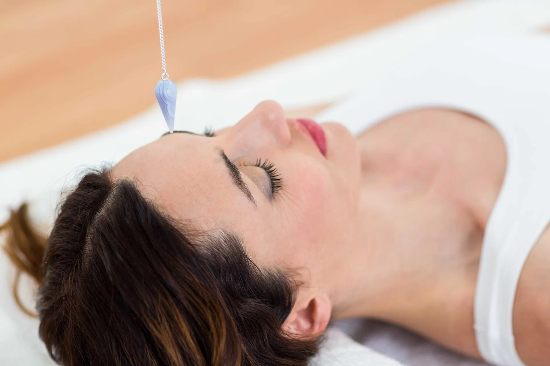 woman-being-hypnotized-while-lying-floor-scaled