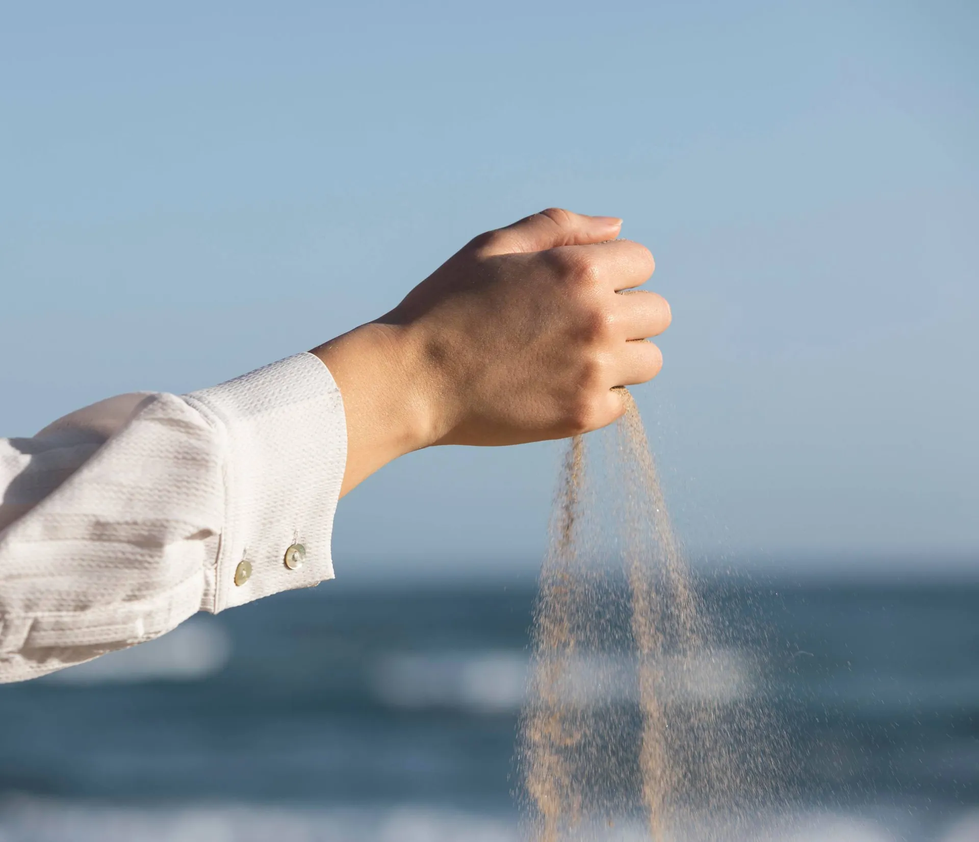 close-up-hand-letting-go-of-sand-1