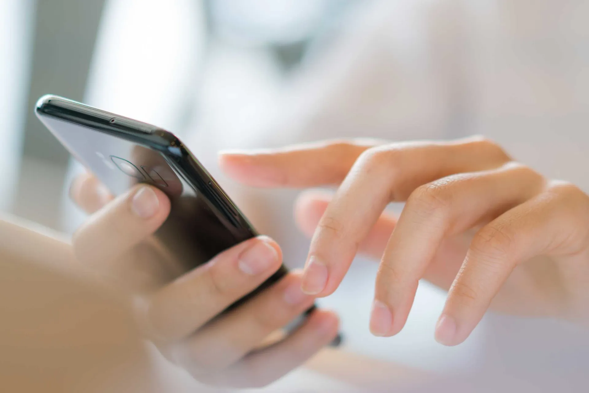 business-hand-with-mobile-phone-scaled